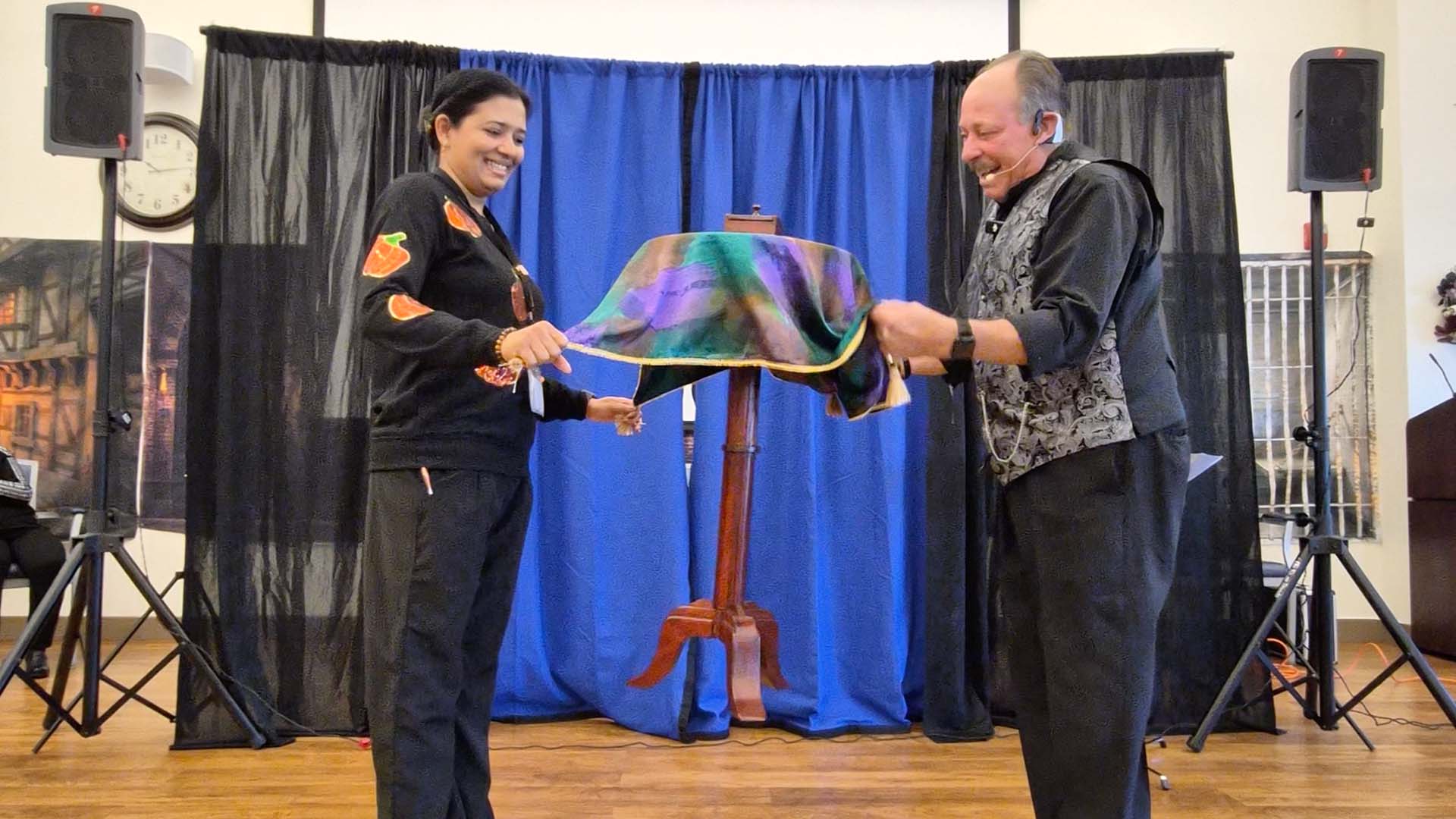 Magicians performing for community members during National Magic Week